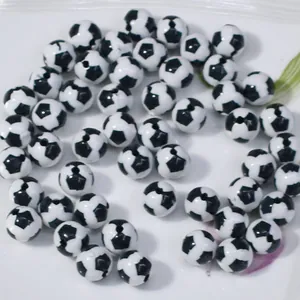 Close-up of black and white soccer ball patterned acrylic beads for DIY jewelry