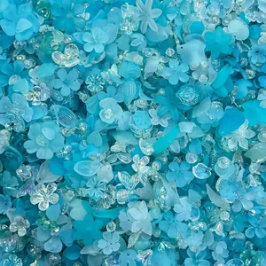 Macro detail of mixed blue acrylic flower and leaf beads for DIY jewelry making