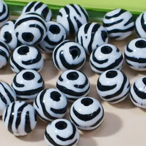 Primo piano di perle tonde in acrilico con motivo zebrato per gioielli DIY