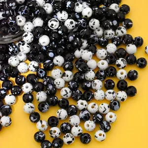 Close-up detail of 8mm black and white speckled acrylic beads for DIY jewelry making