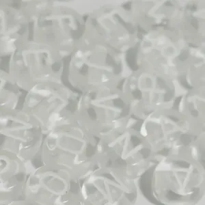 Close-up detail of clear acrylic round alphabet beads with white uppercase letters