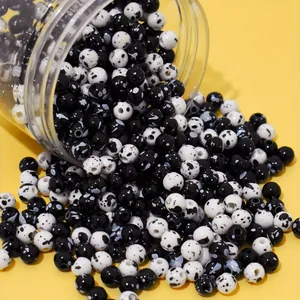 Close-up of 8mm black and white spotted acrylic beads for DIY bracelet making