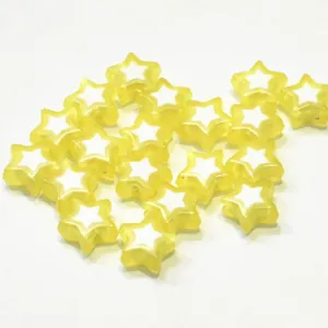 Close-up of yellow star acrylic beads with white star inner core for DIY crafts