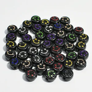 Detailed view of 10mm black acrylic flat beads with multi-colored smiley faces for DIY jewelry
