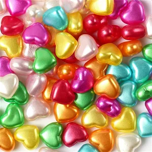 Macro view of colorful heart-shaped ABS pearl beads for handcrafted DIY jewelry making.