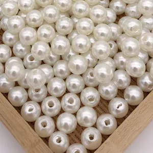 Macro view of round white ABS imitation pearl beads with through-holes for jewelry