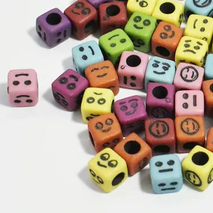 Macro view of colorful 6mm acrylic cube beads with various smiley face expressions