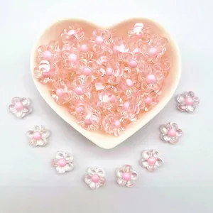 Close-up of 12mm clear acrylic flower beads with pink centers in a heart-shaped bowl