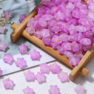 Macro detail of purple matte star beads with gold foil for DIY jewelry making.