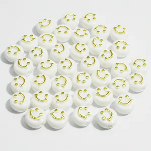 Detail view of 10mm white round acrylic beads with gold smiley face for DIY jewelry crafts