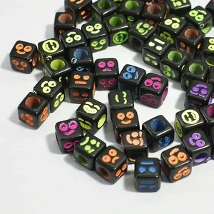 Detailed view of 6mm black acrylic cube beads with colorful emoji smiley faces