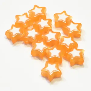 Close-up of orange acrylic star beads with bead-in-bead design for DIY jewelry making