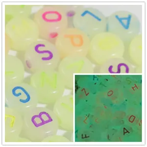 Macro detail of 7mm luminous acrylic letter beads showing glow-in-the-dark effect.