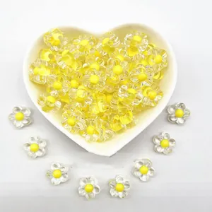 Close-up of 12mm clear acrylic flower beads with yellow center for DIY crafts