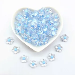 Close-up of 12mm transparent acrylic five-petal flower beads with blue centers for DIY crafts