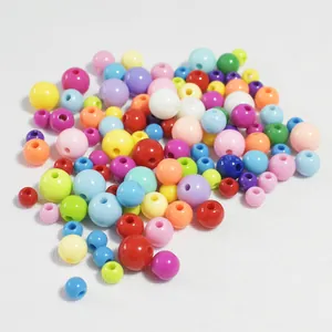 Detailed macro view of mixed solid color acrylic round beads in assorted spring tones