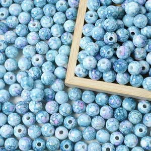 Detailed view of 8mm blue acrylic crackle beads with a speckled ceramic effect