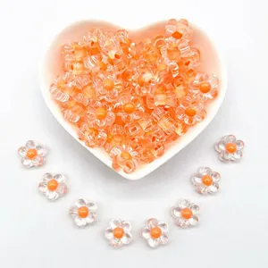 Macro shot of transparent 12mm acrylic flower beads with orange centers