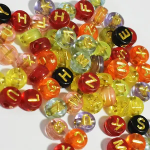 Close-up of colorful translucent 7mm acrylic letter beads with gold embossed alphabets