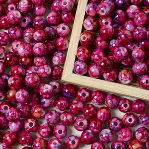 Close-up of 8mm pink acrylic crackle beads with a ceramic marble spray-dot finish