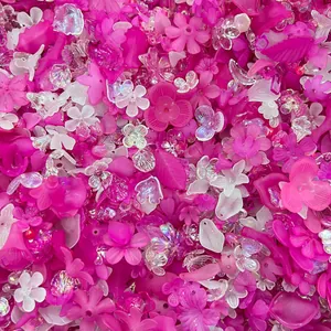 Macro detail of vibrant pink acrylic flower and leaf beads for DIY jewelry accessories