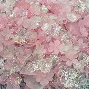 Macro detail showing mixed iridescent pink acrylic flower and leaf beads for DIY jewelry making