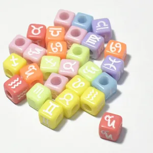 Detailed view of colorful 7mm acrylic square beads with white zodiac symbols.