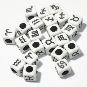 Detailed macro view of 7mm white acrylic square beads with black zodiac sign symbols