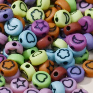 Macro view of 7mm colorful acrylic beads with star and moon patterns for DIY crafting