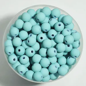 Overhead detail view of 8mm light blue matte spray-painted acrylic beads in a bowl