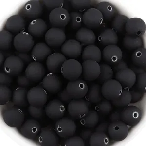 Macro detail view of black matte rubberized acrylic beads used for DIY jewelry making