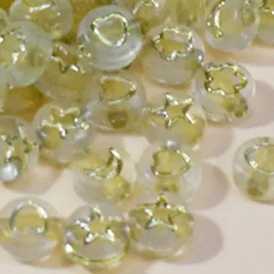 Close-up of 7mm clear acrylic beads with gold stars moons hearts for DIY jewelry