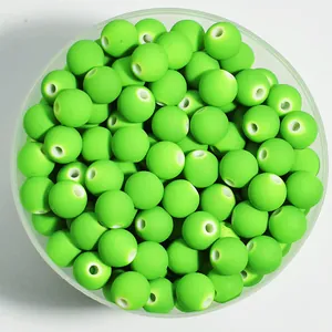 Macro view of 8mm lime green matte spray-painted acrylic beads for DIY crafting