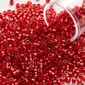 Close-up macro detail of vibrant red 2mm glass seed beads for DIY jewelry making