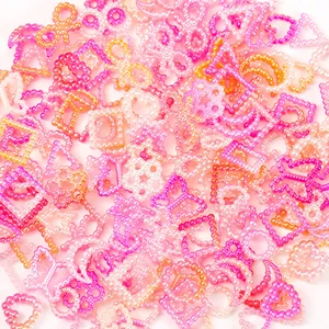 Macro detail of 10-11mm mixed gradient pearl charms in stars moons and flower shapes