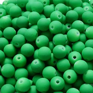 Close-up detail of green matte rubber paint acrylic beads with straight holes for DIY jewelry