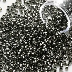 Macro detail of 2mm silver metallic glass seed beads for jewelry making and DIY crafts