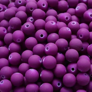Close-up of matte purple rubber-painted acrylic round beads for DIY jewelry making