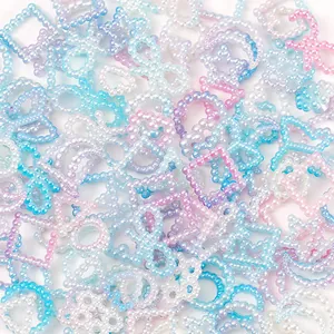 Macro view of colorful gradient pearl beads in star moon and flower shapes for DIY crafts