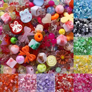 Detail of colorful mixed acrylic cartoon beads for DIY phone strap accessories.