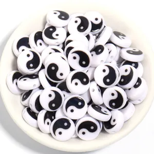 Macro view of white Yin Yang flat acrylic beads for DIY handmade jewelry craft making