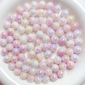 Close-up of iridescent AB coated acrylic beads with a pearlescent shine for jewelry making.