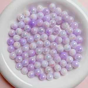 Macro view of 6-10mm iridescent lavender acrylic beads in a white bowl for DIY jewelry