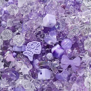 Detailed macro view of purple acrylic mixed beads in bow, heart, and flower shapes