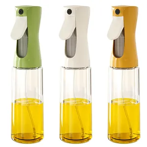 Set of three glass oil spray bottles in green white and orange for kitchen cooking
