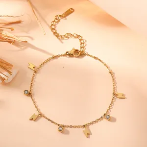 Detailed view of a gold-plated titanium steel bracelet with lightning and CZ charms.