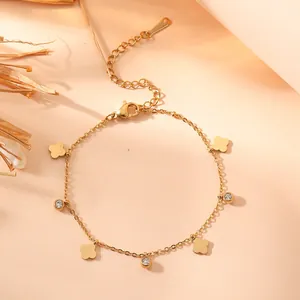 Detailed macro shot of gold titanium steel bracelet with flower pendants and crystals
