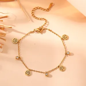 Detailed view of gold titanium steel bracelet with tree of life and crystal charms