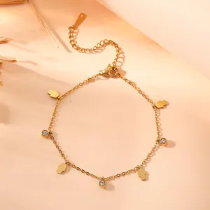 Detailed view of gold titanium steel bracelet with Hamsa hand charms and crystals