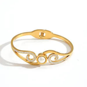 Elegant gold plated stainless steel bangle with pearl and rhinestone wing design